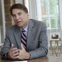 North Carolina Gov. Pat McCrory makes remarks during an interview at the Governor's mansion in Raleigh, North Carolina, Tuesday. McCrory says he wants to change a new state law that prevents people from suing over discrimination in state court, but he's not challenging a measure regarding bathroom access for transgender people. North Carolina backpedals on anti-transgender law but not over lavatories after bank hiring snub