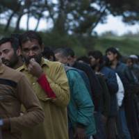 Migrants line up to receive food in a camp set up by volunteers near the port of Mytilini, in the Greek island of Lesbos, Thursday. More than 3500 refugees and migrants are stranded on Lesbos island authorities said. Greece prepares to expel more 'irregular migrants' under EU-Turkey pact