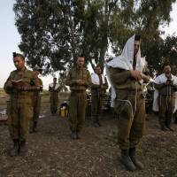 Israeli soldiers pray close to the cease-fire line between Israel and Syria on the Golan Heights, in May 2013. Netanyahu holds Cabinet meeting in Golan Heights, vows land will remain Israel's 'forever'
