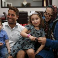 Noah (left) and Lahela al-Amin pose for a picture with their father, Ali Zeid al-Amin, and grandmother in their family home in Beirut on April 8. Beirut judge quizzes Aussie mom, TV crew held over bid to snatch her kids from estranged spouse