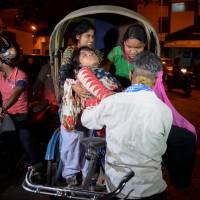 Indian volunteers at Siliguri Hospital help a victim injured during an earthquake in Siliguri on Wednesday. Myanmar was struck by a magnitude-6.9 quake, the U.S. Geological Survey reported, with tremors in India and China sending residents rushing out into the streets. M6.9 temblor jolts Myanmar, felt in India, Bangladesh but no major damage seen