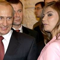 Russian President Vladimir Putin smiles next to Russian gymnast Alina Kabaeva during a meeting with the Russian Olympic team at the Kremlin in 2004. The secret offshore financial dealings of Putin's aides are among a mountain of just-revealed leaked documents on key global figures in politics, sports and other pursuits. Panama Papers bombshell reveals Secom founders' use of offshore tax havens