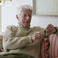 This February photo provided by Dan Shifrin shows his father, 93-year-old Edwin Shifrin, at home in Clayton, Missouri, looking at a prisoner-of-war medal he just received for his World War II military service. The award was expedited by U.S. Sen. Claire McCaskill of Missouri after she was approached by Shifrin’s family about his clever escape from a Nazi prison camp. Missouri vet, 93 who fled stalag after Nazi guards were duped gets POW medal