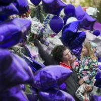 Joy Meuleners holds her niece, Keira Abeln, at a memorial for Prince at Paisley Park on Sunday in Chanhassen, Minnesota. When the music superstar died at age 57, it was in the same suburban Minneapolis studio compound where he had lived for years. He could have opted for the glamor of either coast but stayed home, where fans occasionally saw him in local nightclubs, a record store, or just bicycling near Paisley Park. Minneapolis bells play Prince tribute; finale concert recalled as intimate, playful