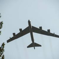 A B-52 bomber from North Dakota does a flyby for the Centennial anniversary of the creation of the La Fayette Escadrille at the Escadrille Memorial in Marnes-la-Coquette, France, Wednesday. The Pentagon said Wednesday the famed Cold War bomber will be used against Islamic State targets. Designed in 1950s, trusty B-52 bomber trotted out for precision strikes against Islamic State