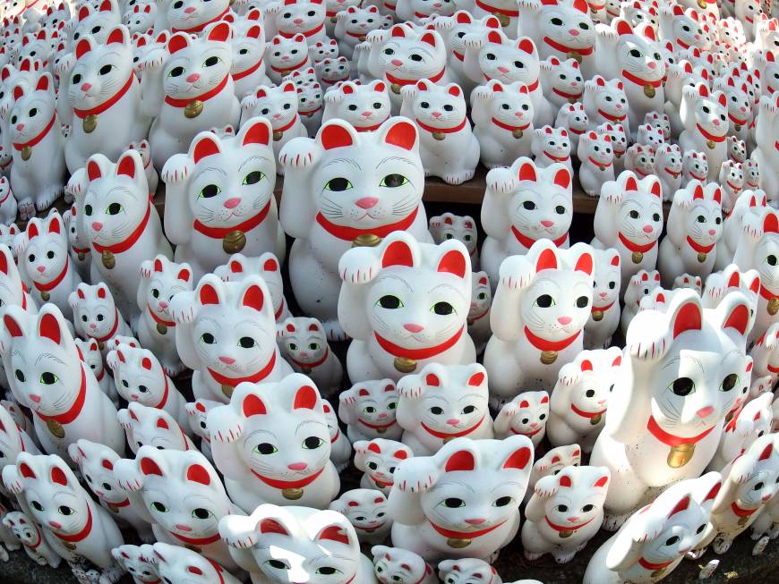 Maneki neko cat ornaments of different sizes are placed at Gotokuji Temple in Tokyo