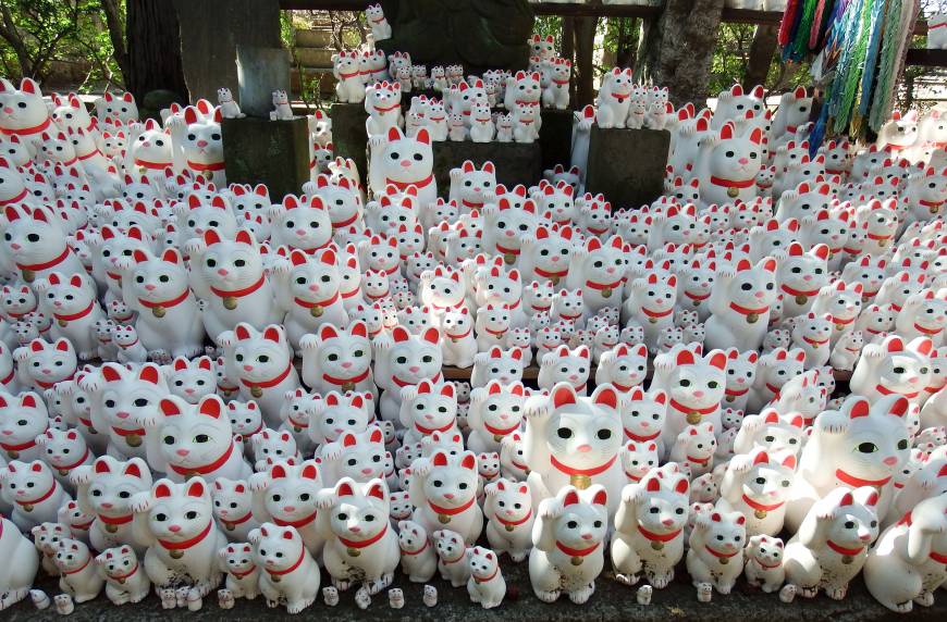 Maneki neko cat ornaments are arranged at Gotokuji Temple in Tokyo