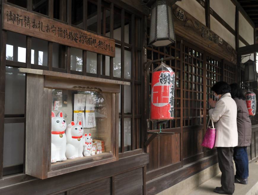 <em>Maneki neko</em> (beckoning cat) figures are seen at Gotokuji Temple in Tokyo’s Setagaya Ward on March 12.