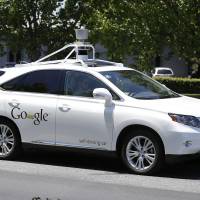 In file photo from May 2014, a Google self-driving car goes on a test drive near the Computer History Museum in Mountain View, Calif. Self-driving vehicle tests won't need permission to use public roads, say NPA guidelines