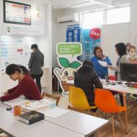 Visitors to a Miyama Smart Energy showroom in Miyama, Fukuoka Prefecture, hear about power options offered. Electricity market shake-up mainly benefiting Tokyo and Kansai
