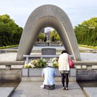 A couple offers prayers at Hiroshima Peace Memorial Park in April 2014. G-7 foreign ministers to weigh nuclear future at Hiroshima meeting