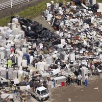 Refrigerators and other appliances proliferate at a disposal site in the town of Mashiki, Kumamoto Prefecture, on Friday. Public housing offers trickle in from around Japan