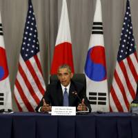 U.S. President Barack Obama takes part in a trilateral meeting with South Korean President Park Geun-hye (left) and Prime Minister Shinzo Abe on the fringes of the Nuclear Security Summit in Washington on Thursday. Trilateral summit tightens Asian leaders' resolve against North Korea