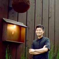 Open door: Chef Zaiyu Hasegawa stands outside the entrance to Den, located down an otherwise unassuming side street in Tokyo’s Jinbocho neighborhood. Chef Zaiyu Hasegawa presents creative takes on dishes that a mother would be proud of
