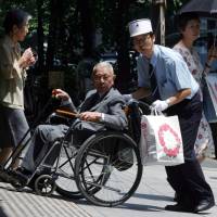 Rocky road: A Takashimaya department store employee helps a customer with a disability in Tokyo. The Law on the Elimination of Discrimination Against Persons with Disabilities, which went into effect April 1, requires businesses to make a “reasonable accommodation” of those with disabilities, but is vague about specifying limitations. Accommodating disabilities, but only within reason