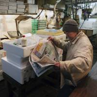 All the news that’s unfit for print: A Japanese fisherman reads the morning paper while waiting for customers in Tokyo’s Tsukiji fish market. Publishers, wary of financial penalties imposed on media companies in defamation lawsuits over the past 20 years are feeding readers trivial, but titillating sexual and financial scandals in lieu of exposing institutional wrongdoing. Ebb tide for press freedoms in Shinzo Abe's Japan
