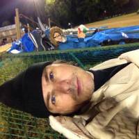 Sean Michael Wilson gets some rest on a pushed-down fence after evacuating in Kumamoto. Dispatches from the Kumamoto quake zone