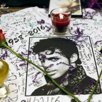 Year the music died: Prince fans created a makeshift memorial outside New York’s Apollo Theater last week. Prince, Haggard, Bowie, White, Frey: 2016 has been a lousy year for music