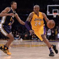 Lakers star Kobe Bryant drives against Jazz guard Rodney Hood during the final game of his career on Wednesday in Los Angeles. Kobe signs off with 60-point night