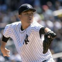 Yankees pitcher Masahiro Tanaka delivers during New York’s victory over Seattle on Sunday. Tanaka outduels former teammate Iwakuma