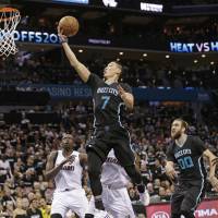 Hornets guard Jeremy Lin goes up for a layup against the Heat during Game 3 on Saturday in Charlotte. Hornets end long wait for victory