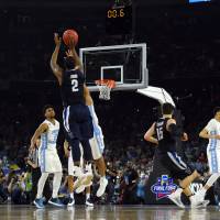 Villanova's Kris Jenkins (2) hits the game-winning shot against North Carolina in the NCAA Tournament title game in Houston on Monday. Villanova won 77-74. Villanova wins national title on buzzer-beater