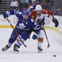 Toronto's Michael Grabner (left) and Florida's Quinton Howden compete for the puck on Monday. Panthers set franchise points record