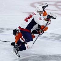 Washington's Evgeny Kusnetzov (front) and Philadelphia's Shayne Gostisbehere collide during Monday's game. Capitals move within win of sweep