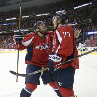 The Capitals’ T.J. Oshie (right) celebrates with teammate Alex Ovechkin after his overtime goal on Thursday. Oshie scores in overtime to lift Capitals over Penguins in Game 1