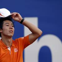 Japan's Kei Nishikori wipes sweat away from his head during the Barcelona Open final against Rafael Nadal of Spain on Sunday. Nadal defeats Nishikori in battle of Barcelona champions