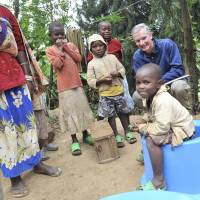 Co-inventor Jim McHale (right) field tests a new model of the SaTo pan in Rwanda. Lixil, Saraya working to address hygiene issues
