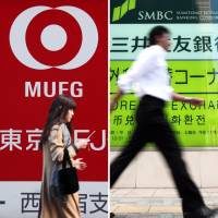 This combination photo shows mega-bank logos at their branches in Tokyo. The country's financial regulator is reportedly stepping up oversight of major banks. Japan's financial regulator to scrutinize banks' stress tests