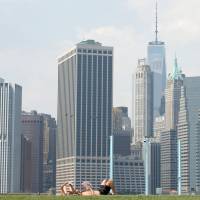 The skyline of Lower Manhattan is seen as people lay on the grass in Brooklyn Bridge Park in the Brooklyn borough of New York City Friday. $250 million list price eyed for Manhattan skyscraper's 'trophy apartment'