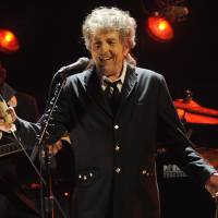 Meeting of the gods: Bob Dylan performs in Los Angeles in 2012. The artist was announced as one of a slew of rock legends who will perform at a three-day event in California in October. The Stones, Dylan, McCartney in line-up for mega concert
