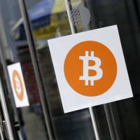 Bitcoin logos are displayed at the Inside Bitcoins conference and trade show in New York in April 2014. Australia to sell bitcoins, worth about $13 million, confiscated as proceeds of crime