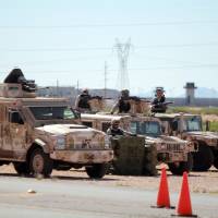 Mexican army soldiers stand guard aboard thier vehicles parked outside of the the Cefereso No. 9 prison on the outskirts of Ciudad Juarez, Mexico, May 9. Top Mexican drug lord, Joaquin El Chapo Guzman was moved from a prison outside Mexico City to this one in Ciudad Juarez near the U.S. border. Second Mexican judge OKs extradition of 'El Chapo' to U.S.