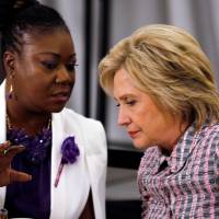Democratic U.S presidential candidate Hillary Clinton listens to Sabrina Fulton, mother of Trayvon Martin, before her remarks at the Circle of Mothers, Trayvon Martin Foundation Gala in Fort Lauderdale, Florida, Sunday. Trump's gun policies, mixed with his rhetoric of hate and division, are downright dangerous: Clinton