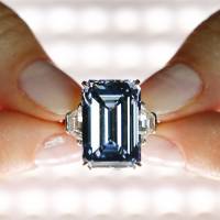A Christie's employee shows the 14.62-carat Oppenheimer Blue diamond in Geneva on May 12. Record crushed, diamond intact: 'Oppenheimer Blue' draws $58M