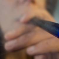 A woman smokes a Blu e-cigarette (electronical cigarette) in Washington,D.C. The U.S. Thursday issued a sweeping ban on sales of e-cigarettes, cigars, pipe tobacco and hookahs to those under 18, marking the first time these products have been federally regulated. The ban will go into effect in 90 days, according to the Food and Drug Administration, which described the final rule — issued after several years of study and debate — as historic. FDA e-cigarettes age restriction a 'common sense' proposal: White House