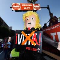 Protesters hold an effigy of U.S. Republican presidential hopeful Donald Trump during a May Day rally in Los Angeles Sunday. Trump foes figure as U.S. cities' May Day marches call for immigrant, and worker, rights