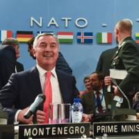 Montenegro's Prime Minister Milo Dukanovic (left) attends a NATO foreign ministers' meeting next to NATO Secretary General Jens Stoltenberg at NATO headquarters in Brussels on Thursday. NATO formally invites Montenegro as 29th member