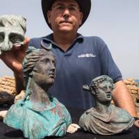 Jacob Sharvit, director of the Marine Archaeology Unit of Israel's Antiquities Authority, presents to the press artefacts from a merchant ship that sank off the ancient Mediterranean port of Caesarea 1,600 years ago, on Monday. The find, happened upon by two divers a few weeks ago who then alerted the authority, consisted primarily of metal slated for recycling borne on the ship from Caesarea in the late Roman period, IAA experts said. Israeli divers find 1,700-year-old shipwrecked Roman treasure trove