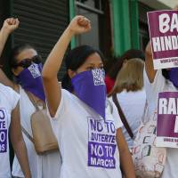 Protesters clench their fists as they block traffic in protest of Philippine presidential candidate Rodrigo Duterte and vice-presidential candidate Ferdinand “Bongbong” Marcos Jr., in Quezon city, the Philippines, on Thursday. Philippine election could cause heartburn in Washington