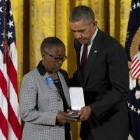 President Barack Obama presents Constance Wilson, grandmother of fallen Philadelphia Police Department Sgt .Robert Wilson III, with his Medal of Valor during a ceremony in the East Room of the White House in Washington Monday. The Medal of Valor is awarded to public safety officers who have exhibited exceptional courage, regardless of personal safety, in the attempt to save or protect others from harm. Obama bestows Medal of Valor on 13 law enforcement officers