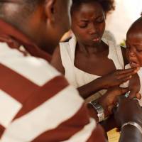 A health worker injects a young boy with yellow fever vaccine in Seguela in northern Cote d'Ivoire in 2011. On Thursday, the U.N. health agency convened an expert committee to consider whether the epidemic of yellow fever, an acute viral hemorrhagic fever, qualifies as an international public health emergency. WHO terms deadly African urban yellow fever outbreak 'serious' but not global crisis, yet