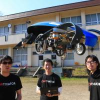 Tsubasa Nakamura (center) and his fellow engineers test a prototype flying car in Toyota, Aichi Prefecture. With quake disruptions in mind, Aichi team working on flying car