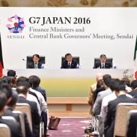 Finance Minister Taro Aso and Bank of Japan Gov. Haruhiko Kuroda address reporters in Sendai on Saturday. G-7 finance leaders reject coordinated action to revitalize global economy