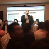 Stormy session: Porn director Goro Tameike (standing) exchanges angry words with former porn actor Kenji Kubodera at the meeting held on May 4, seconds before Kubodera was ejected from the venue in Koenji, Tokyo. Kubodera (whose stage name was Thunder Kid) said he was tortured during his days as an actor in the business. Do Japan's porn actresses and actors have labor rights?