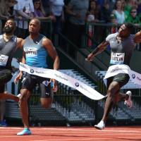Justin Gatlin (right) crosses the finish line to win the 100-meter race at the Prefontaine Classic on Saturday. Gatlin races to win in 100 at Prefontaine Classic