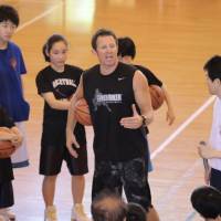 Instructor Ganon Baker speaks to participants during his basketball clinic on May 5 in Koshigaya, Saitama Prefecture. Baker brings skills clinics to Japan